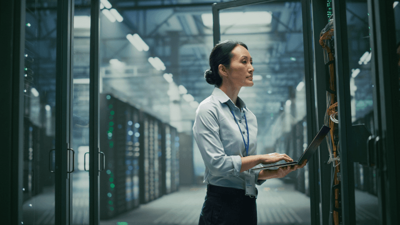 Female Working In A Dark Data Center