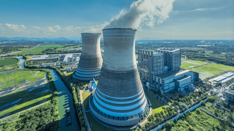 Aerial View Of Power Plant With Cooling Towers And River Landscape