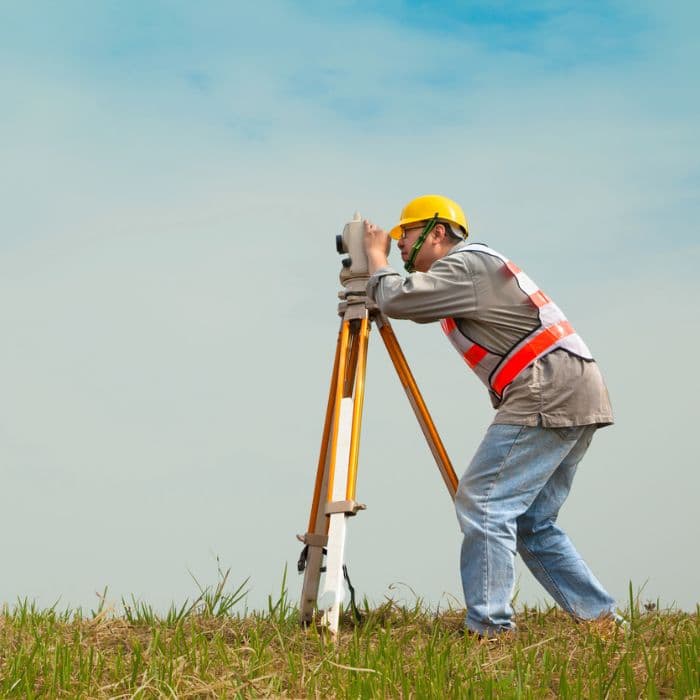 Land Surveyor Engineer Making Measure On The Field