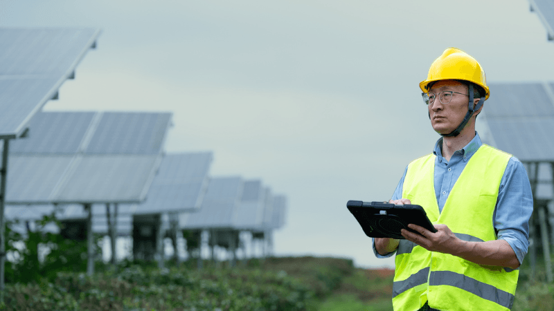 Technician Working In Solar Power Station