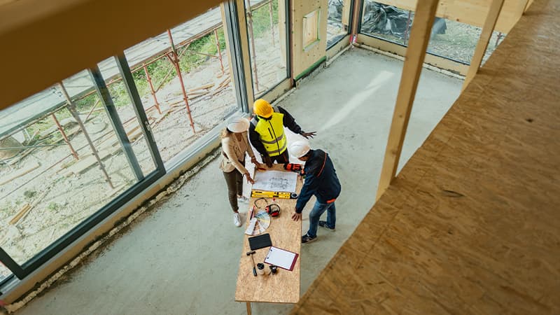 Case Study - Supporting Above and Beyond Talent to Win Landmark Project - One Women Architect And Two Men Architects On A Construction Site